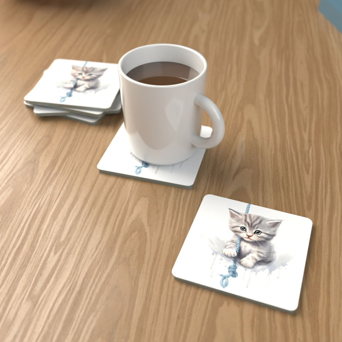 Grey Tabby Kitten on a Rope Square Glass Coasters – Set of 6 – lifestyle mockup with a mug of coffee