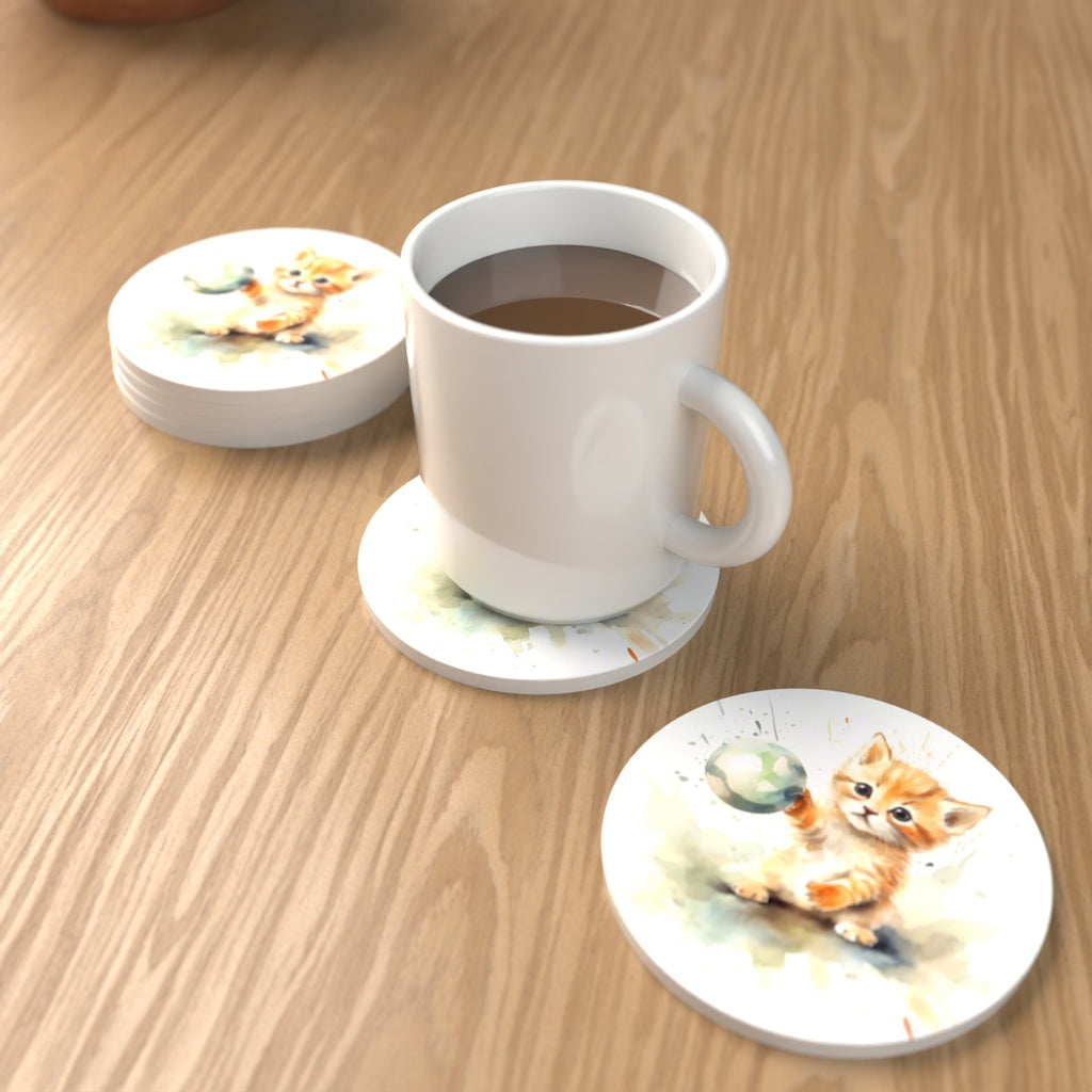 Ginger Kitten Playing with a Ball Round Ceramic Coasters – Set of 6 – lifestyle mockup with a mug of coffee