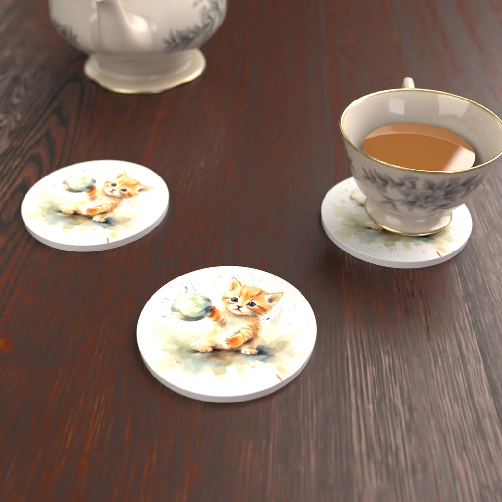 Ginger Kitten Playing with a Ball Round Ceramic Coasters – Set of 6 – lifestyle mockup with a teacup