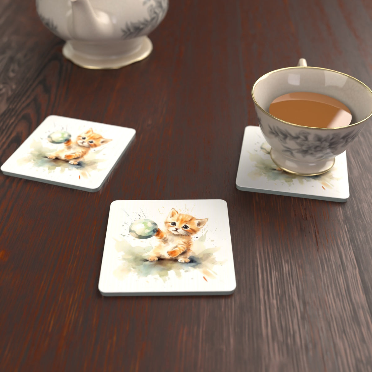 Ginger Kitten Playing with a Ball Square Glass Coasters – Set of 6 – lifestyle mockup with a teacup