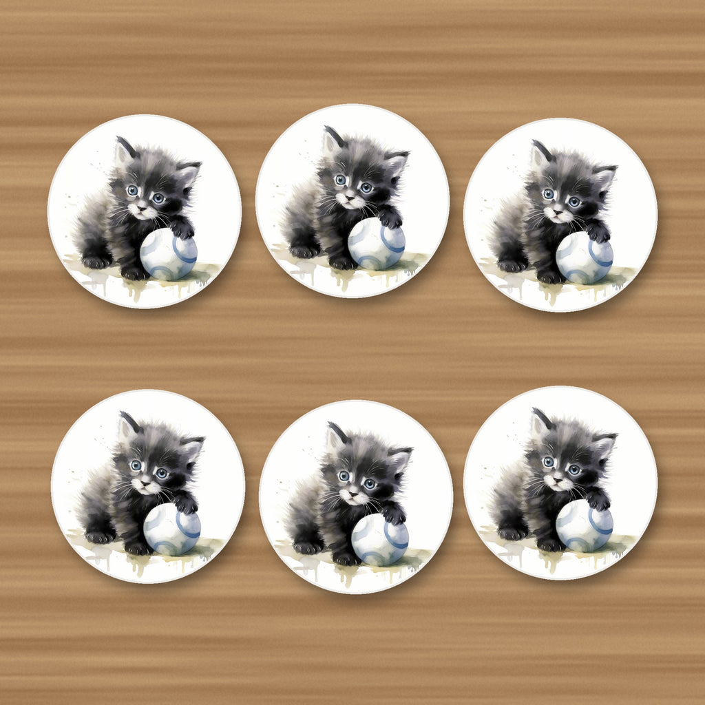 Black Kitten with a Ball round ceramic coasters, set of 6, on an oak coffee table