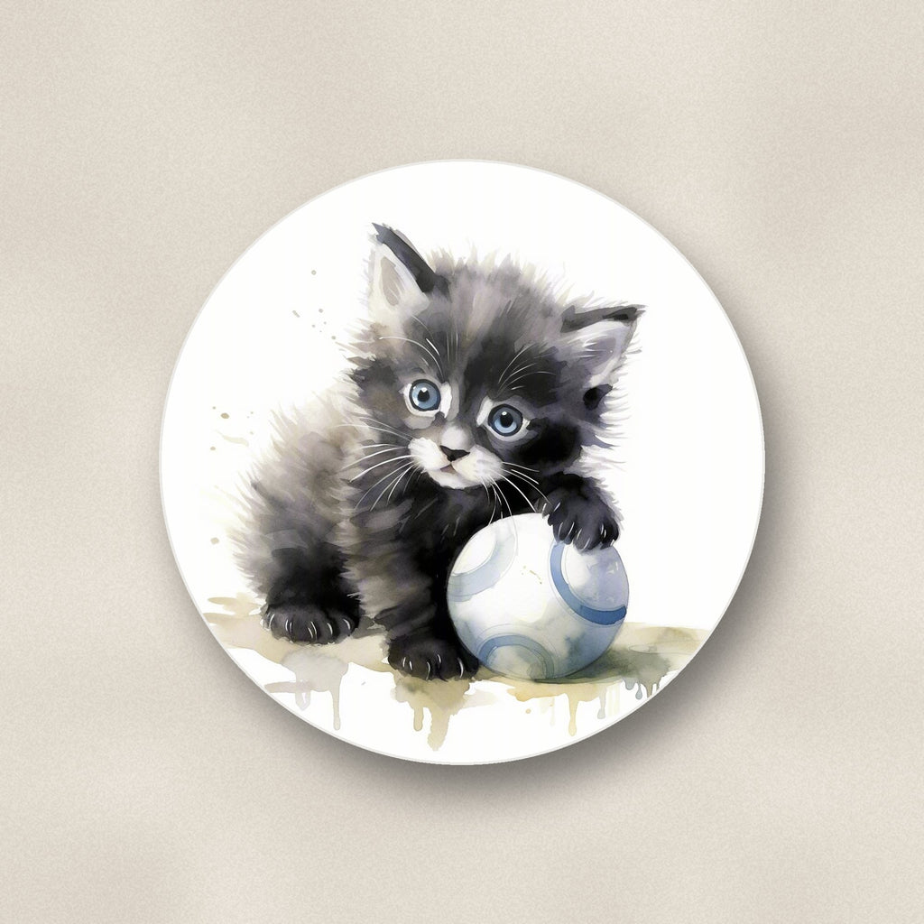 Close-up of one black kitten with a ball round ceramic coaster, flat UV print