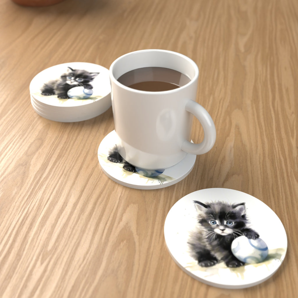 Black Kitten with a Ball Round Ceramic Coasters – Set of 6 – lifestyle mockup with a mug of coffee