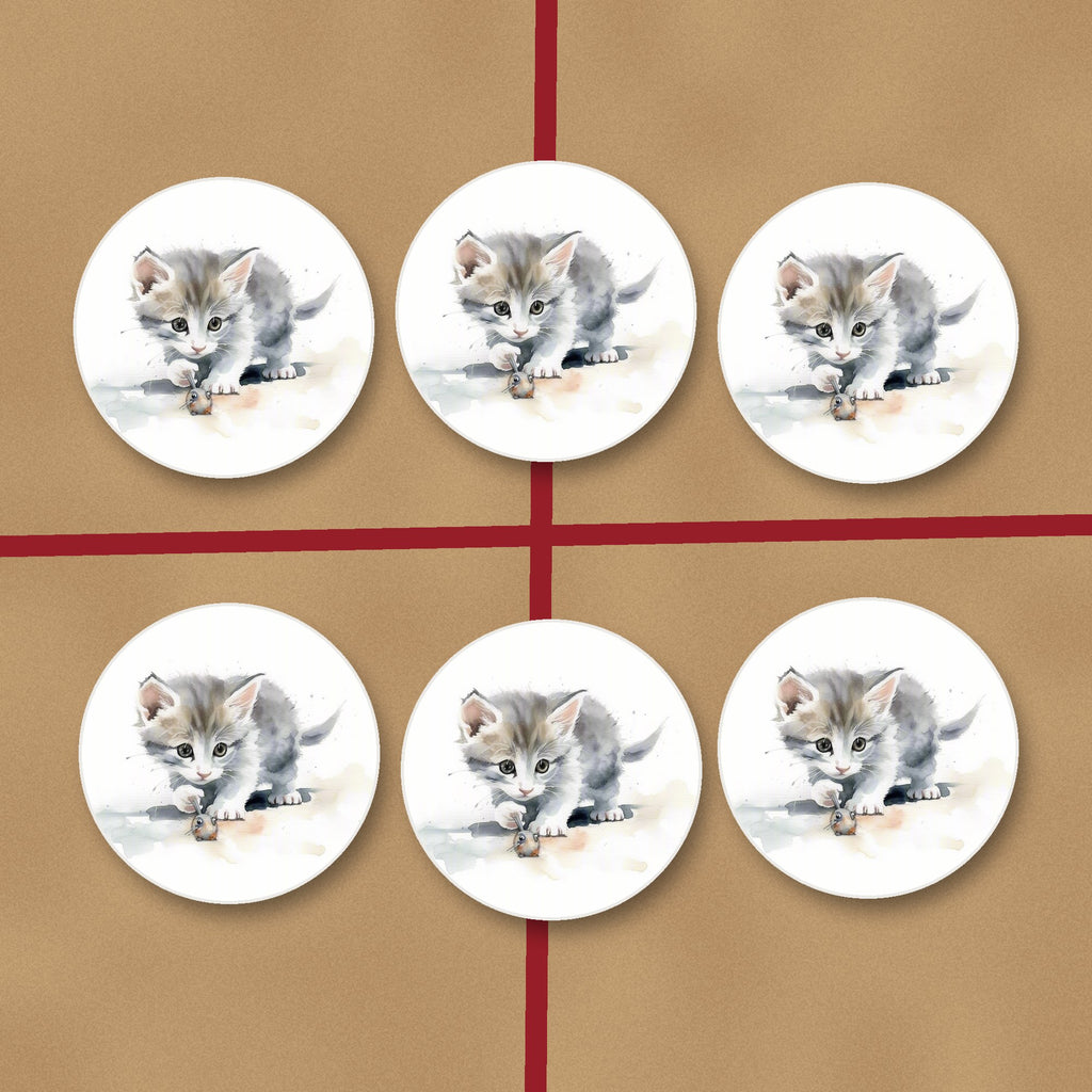 Grey Kitten at Play round ceramic coasters on kraft gift wrap