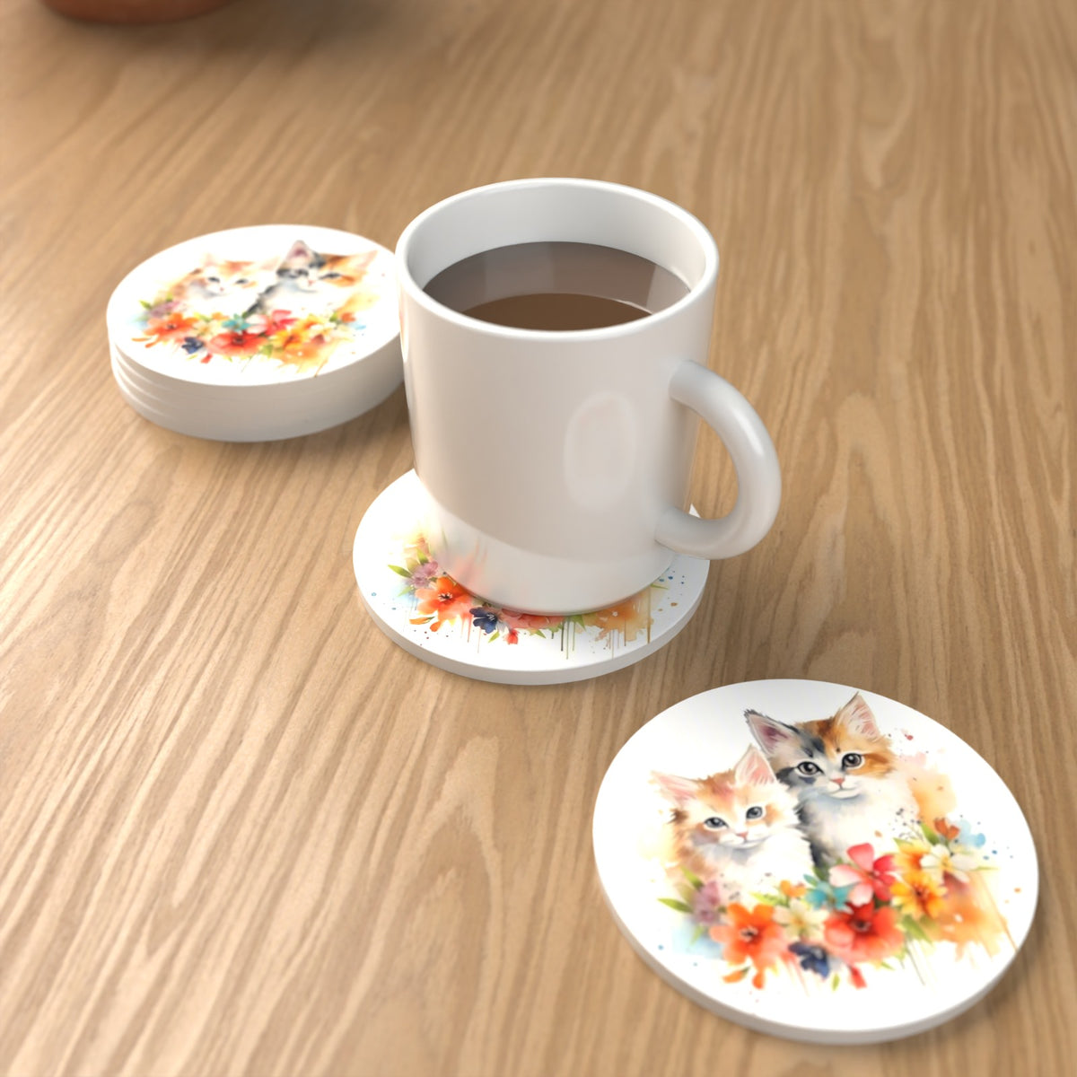 Two Kittens with Flowers Round Ceramic Coasters – Set of 6 – lifestyle mockup with a mug of coffee