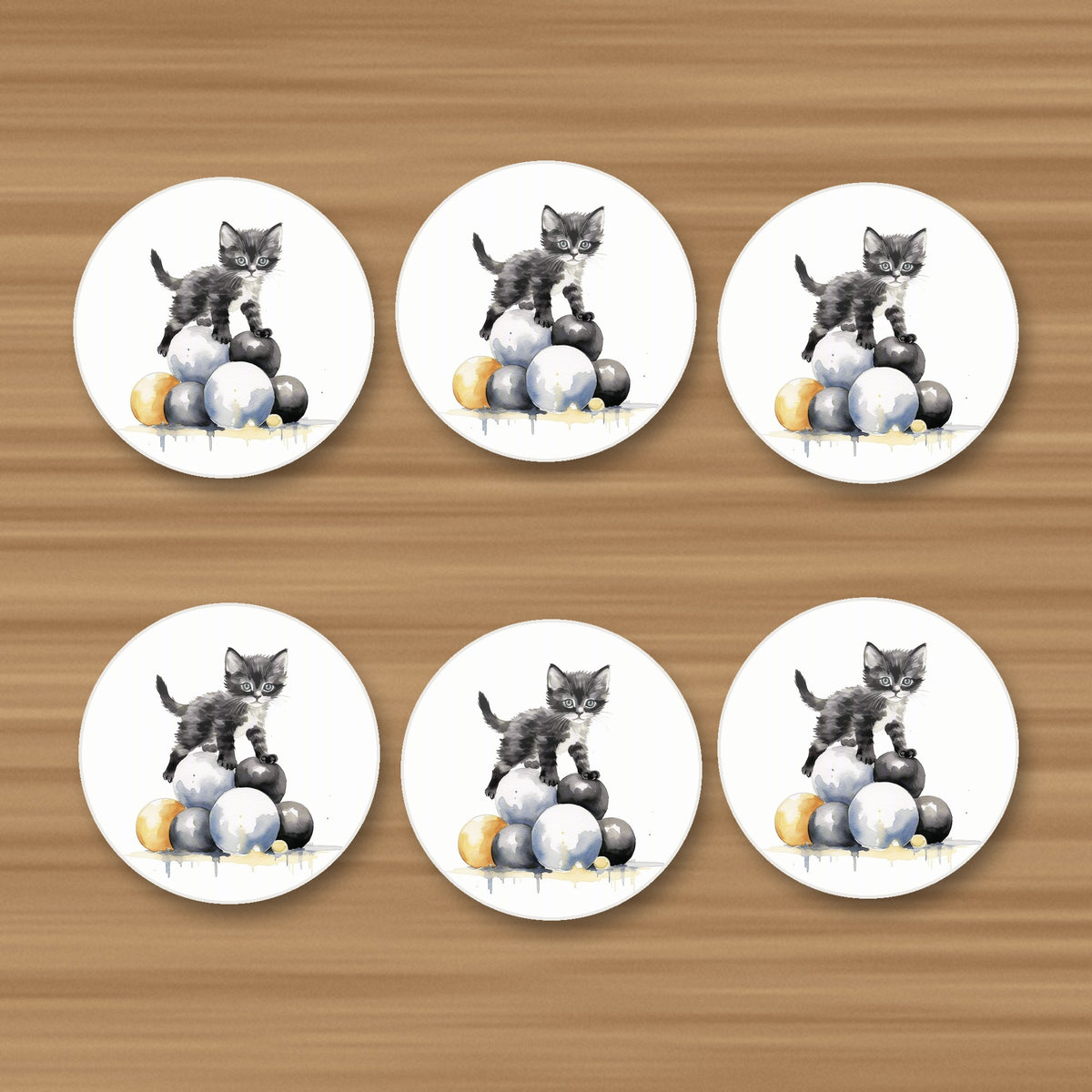 Black Kitten on a Pile of Balls round ceramic coasters, set of 6, on an oak coffee table