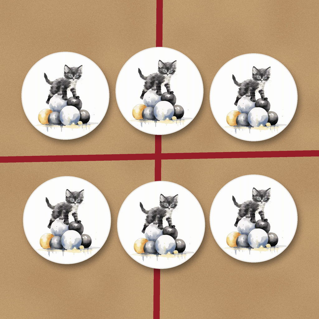 Black Kitten on a Pile of Balls round ceramic coasters on kraft gift wrap