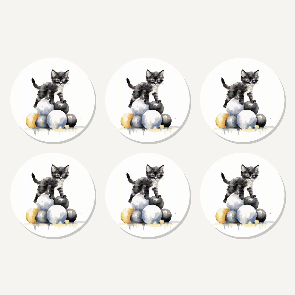 Flat lay of the black kitten on a pile of balls artwork on six round coasters