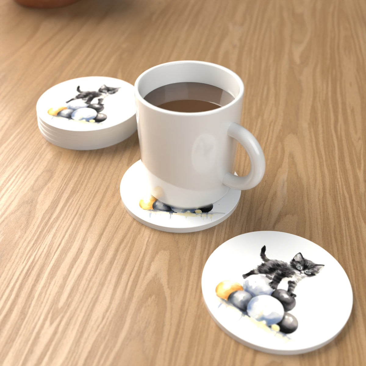 Black Kitten on a Pile of Balls Round Ceramic Coasters – Set of 6 – lifestyle mockup with a mug of coffee