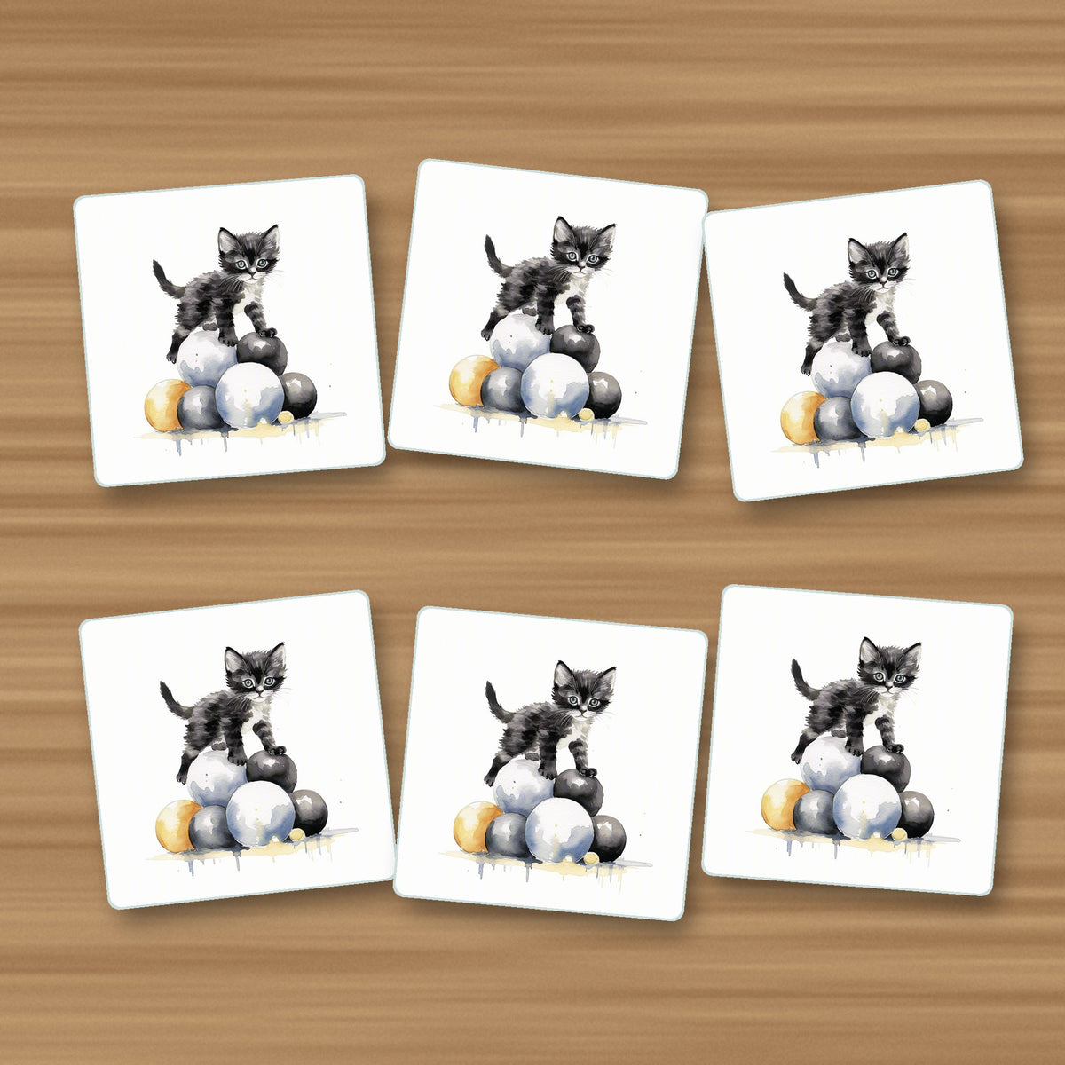 Black Kitten on a Pile of Balls square glass coasters, set of 6, on an oak coffee table