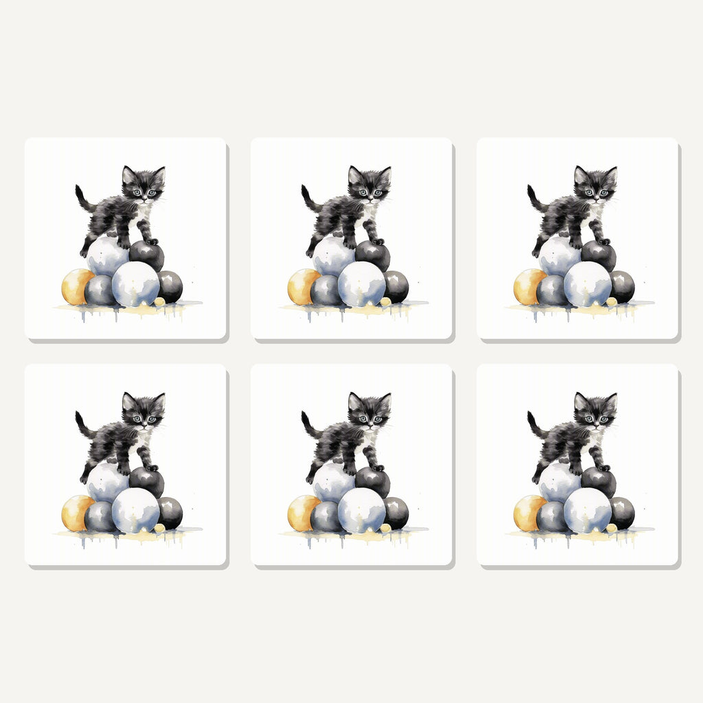 Flat lay of the black kitten on a pile of balls artwork on six square coasters