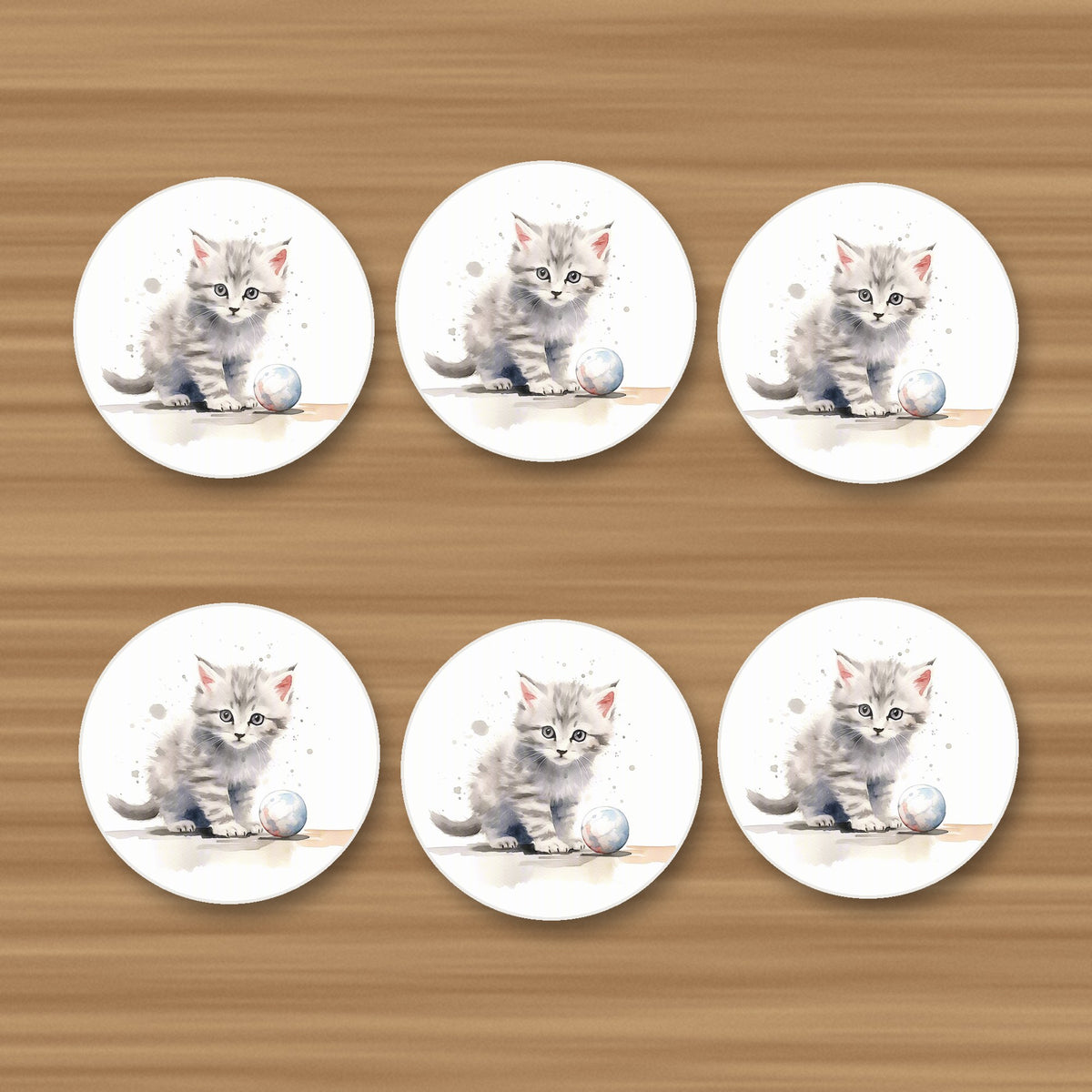 Grey Tabby Kitten with a Ball round ceramic coasters, set of 6, on an oak coffee table