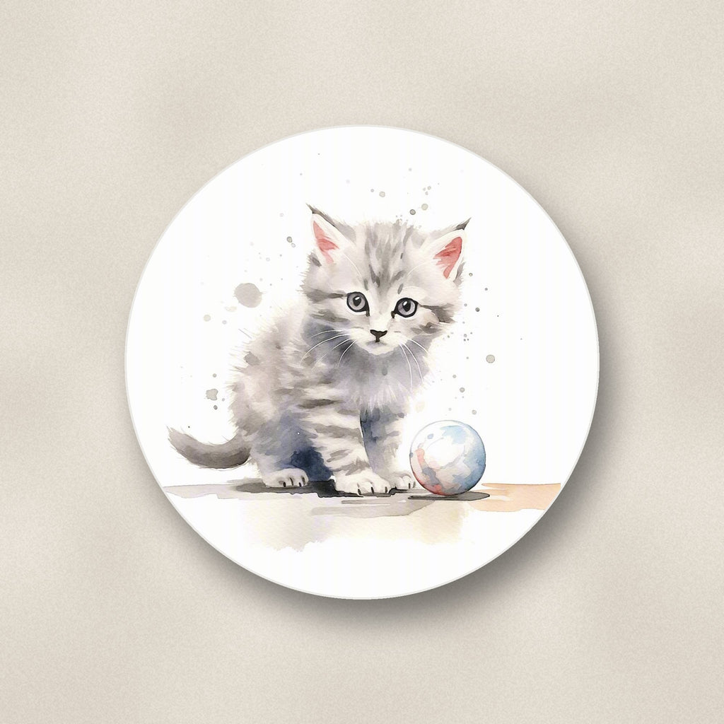 Close-up of one grey tabby kitten with a ball round ceramic coaster, flat UV print