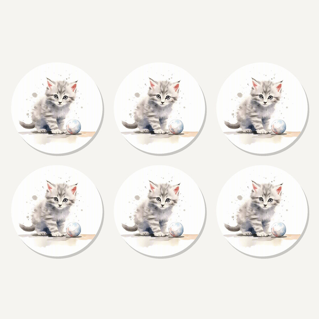 Flat lay of the grey tabby kitten with a ball artwork on six round coasters