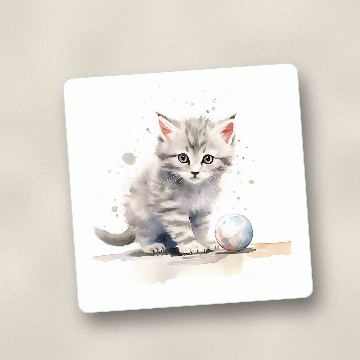 Close-up of one grey tabby kitten with a ball square glass coaster, flat UV print