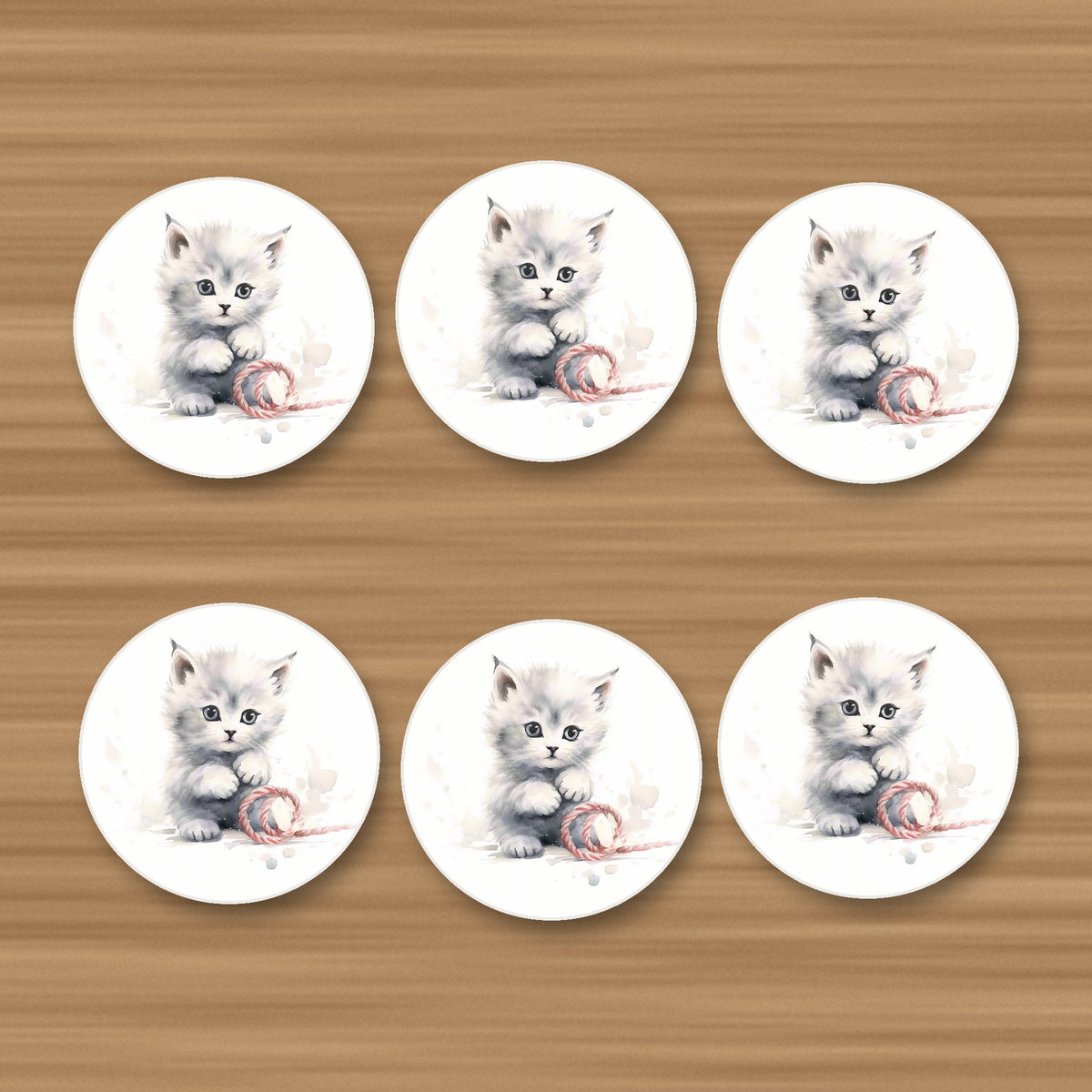White Kitten with Yarn round ceramic coasters, set of 6, on an oak coffee table