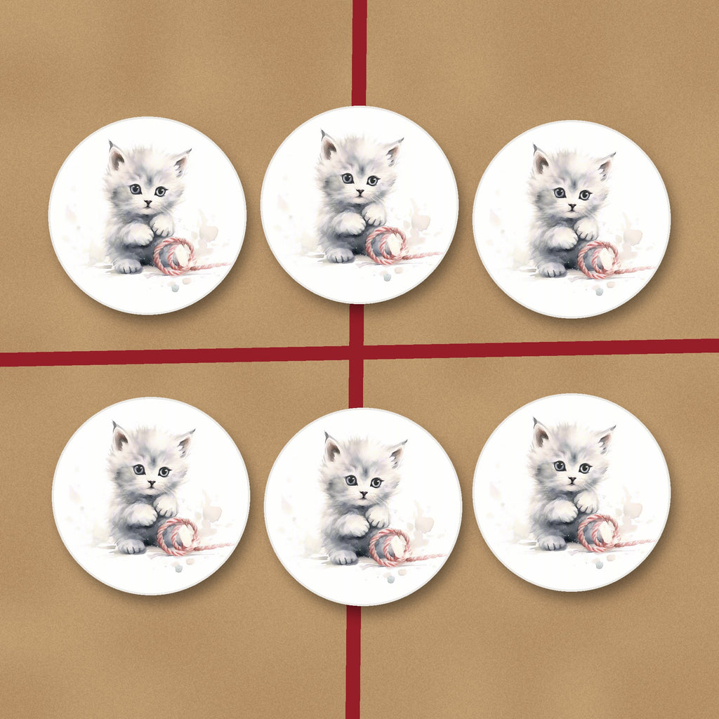 White Kitten with Yarn round ceramic coasters on kraft gift wrap