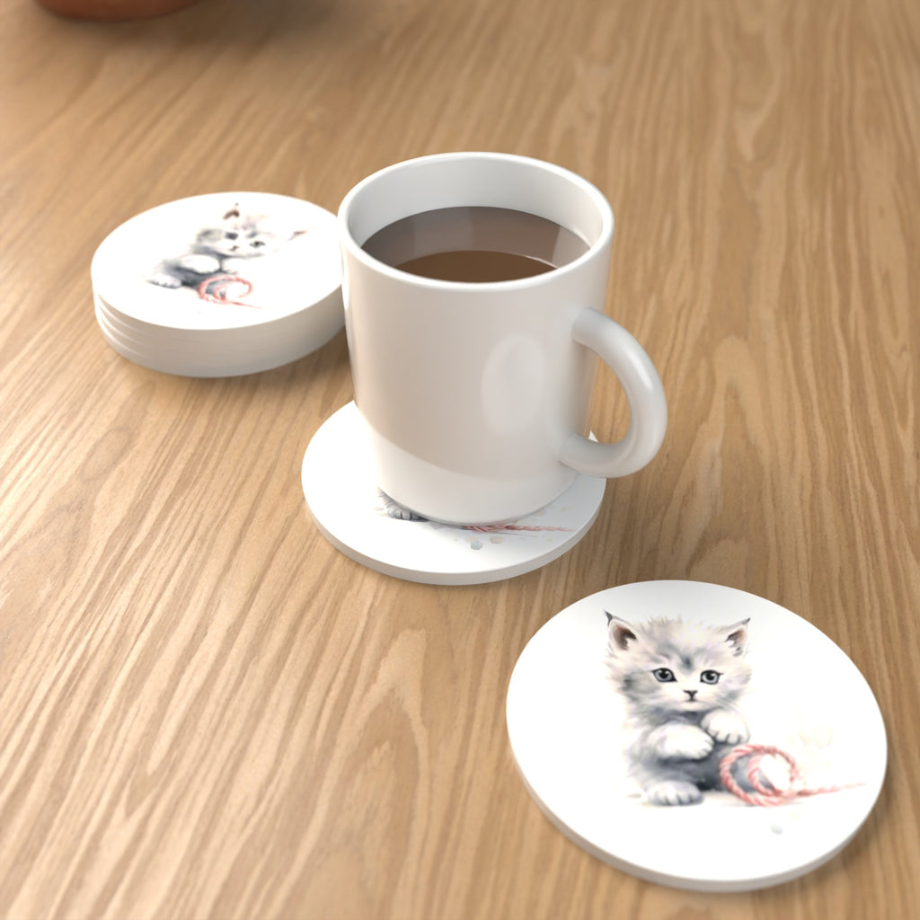 White Kitten with Yarn Round Ceramic Coasters – Set of 6 – lifestyle mockup with a mug of coffee