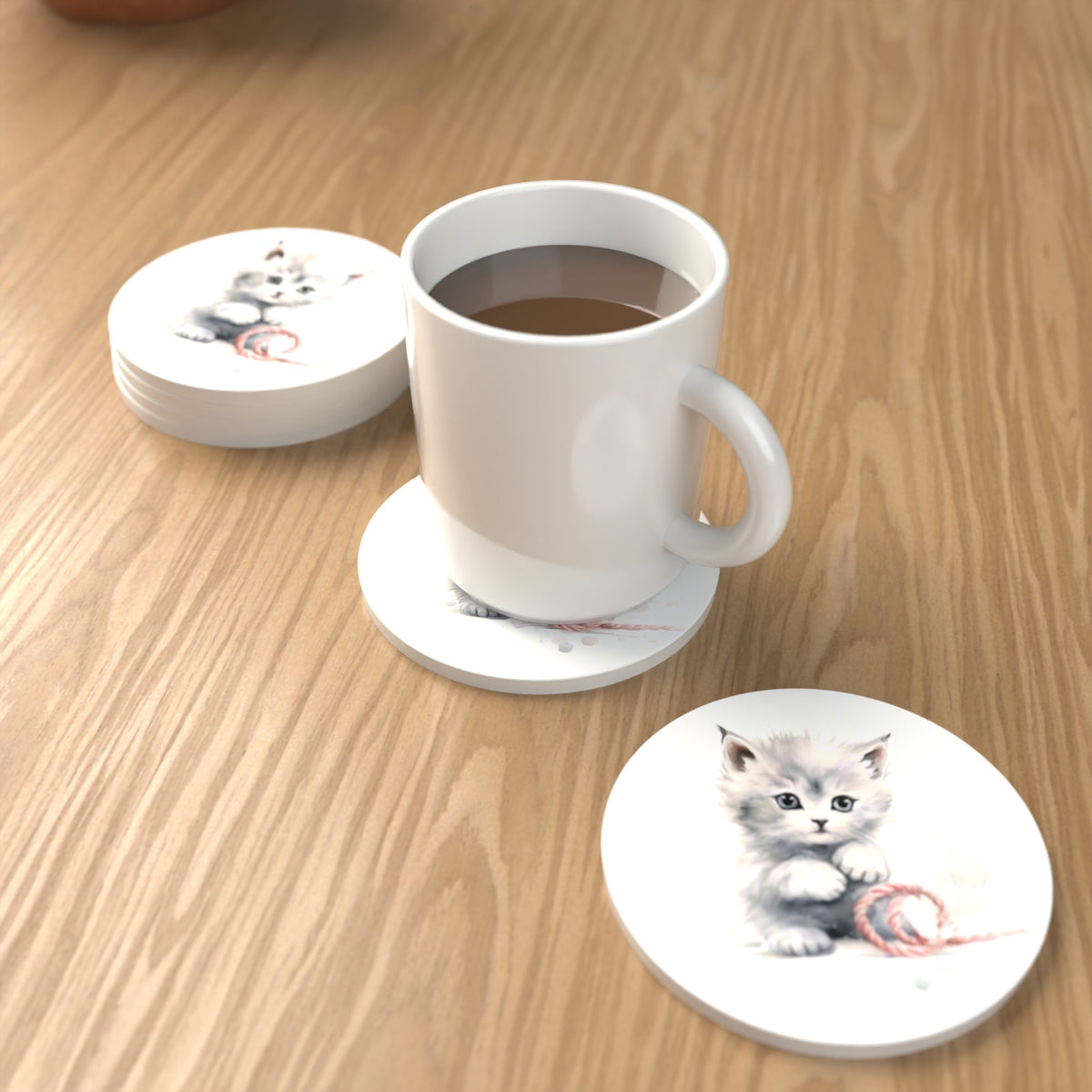 White Kitten with Yarn Round Ceramic Coasters – Set of 6 – lifestyle mockup with a mug of coffee