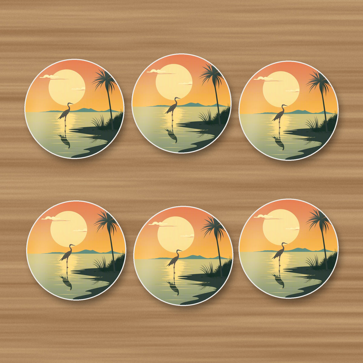 Heron at Sunset round ceramic coasters, set of 6, on an oak coffee table