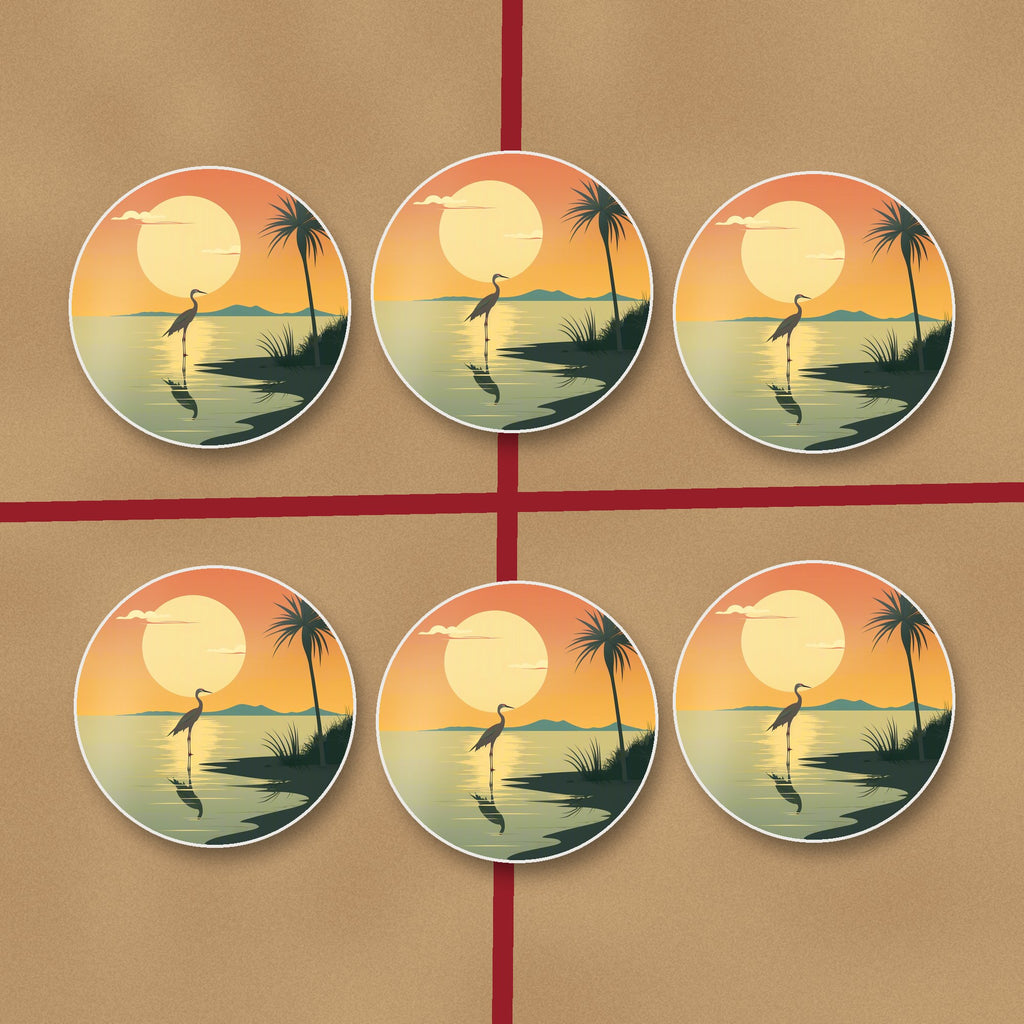 Heron at Sunset round ceramic coasters on kraft gift wrap