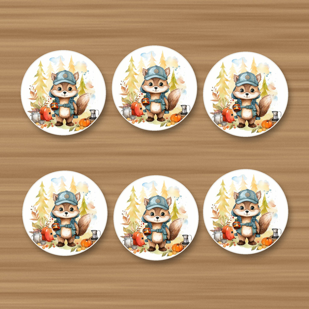 Squirrel Camper round ceramic coasters, set of 6, on an oak coffee table