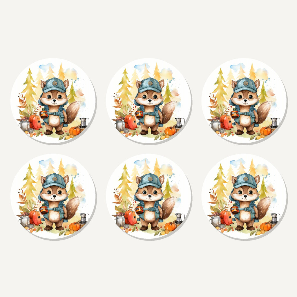 Flat lay of the squirrel camper artwork on six round coasters