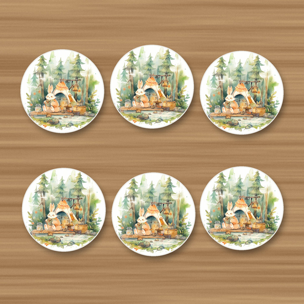 Rabbit Campsite in the Pines round ceramic coasters, set of 6, on an oak coffee table