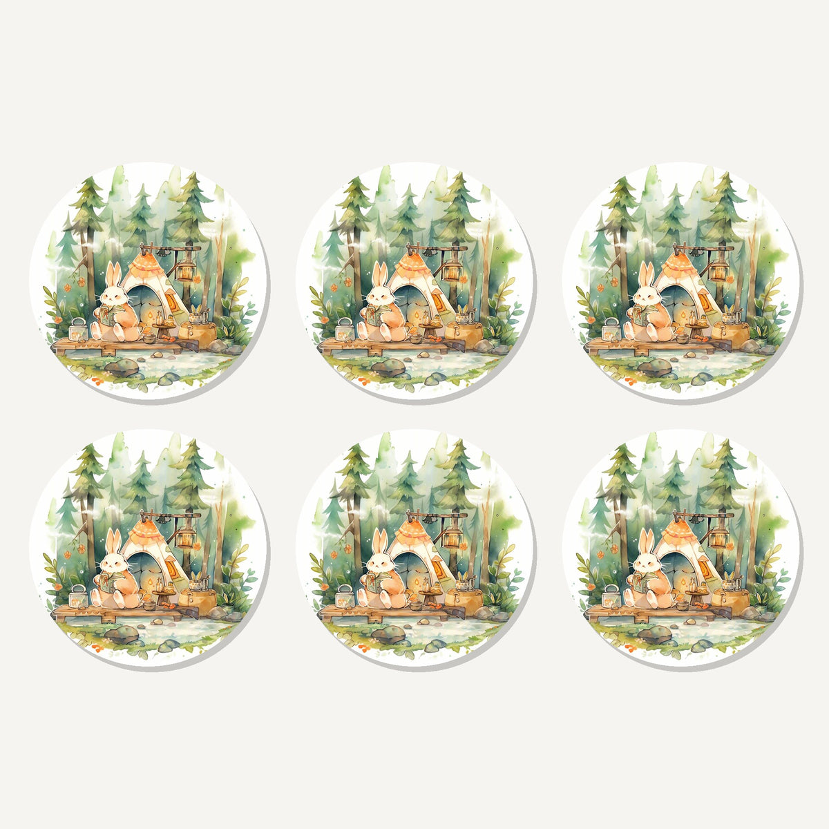 Flat lay of the rabbit campsite in the pines artwork on six round coasters