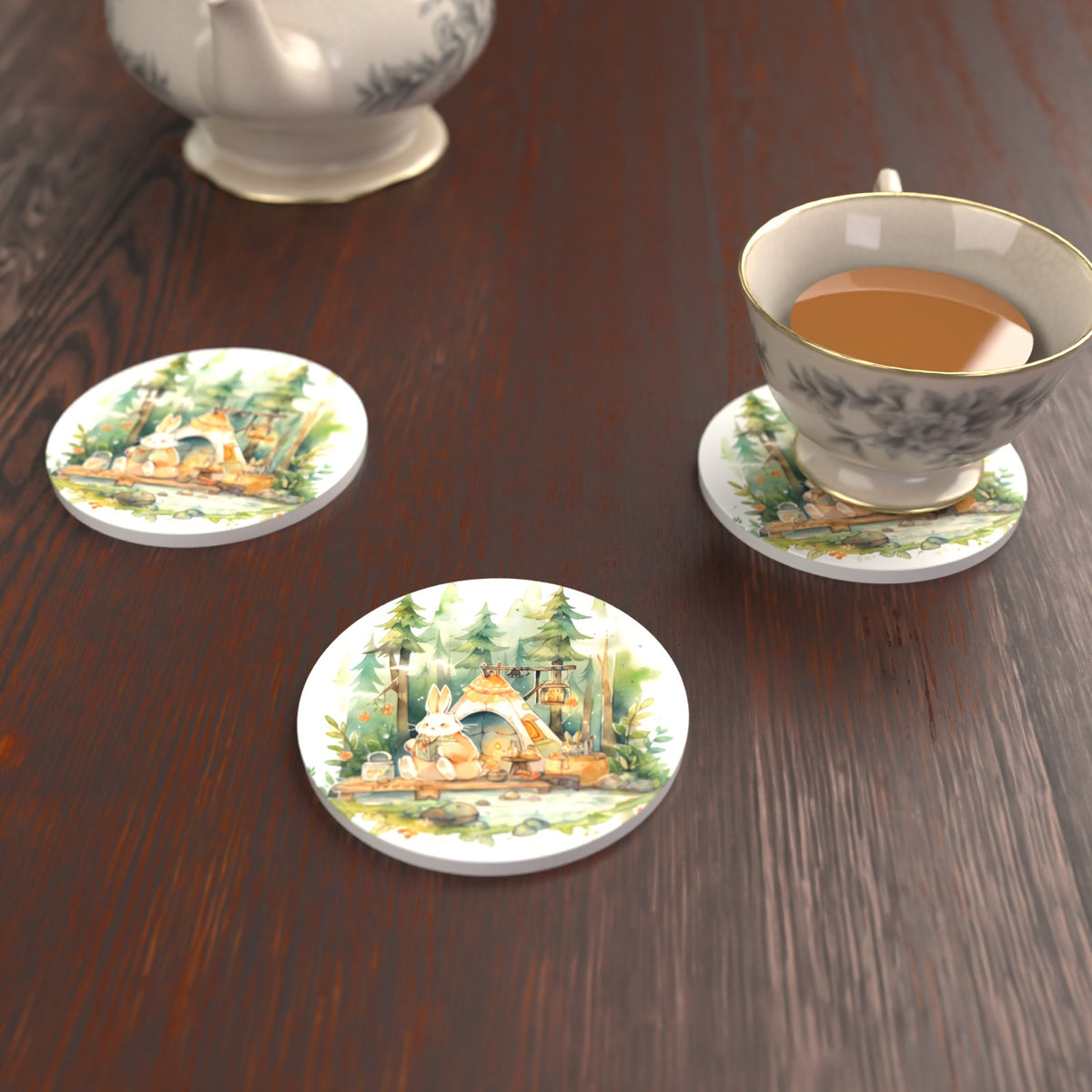 Rabbit Campsite in the Pines Round Ceramic Coasters – Set of 6 – lifestyle mockup with a teacup