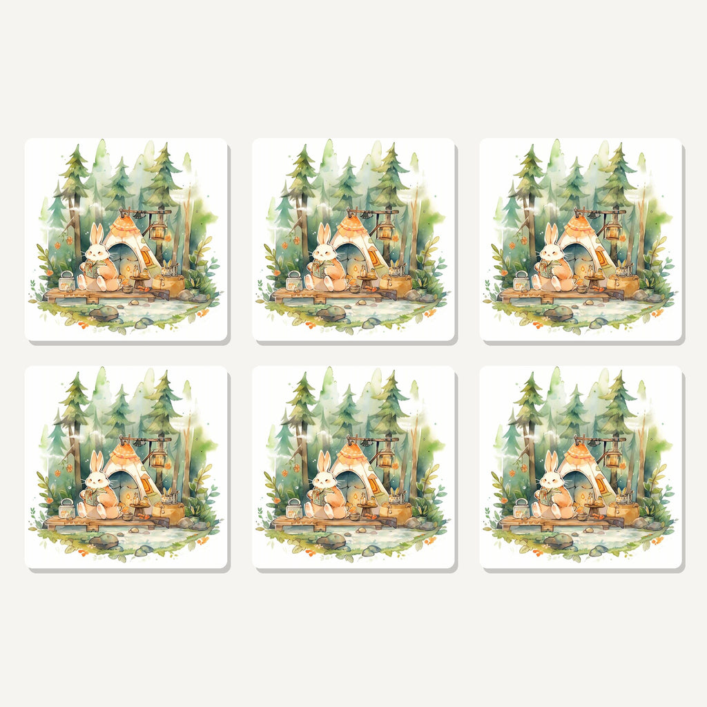 Flat lay of the rabbit campsite in the pines artwork on six square coasters