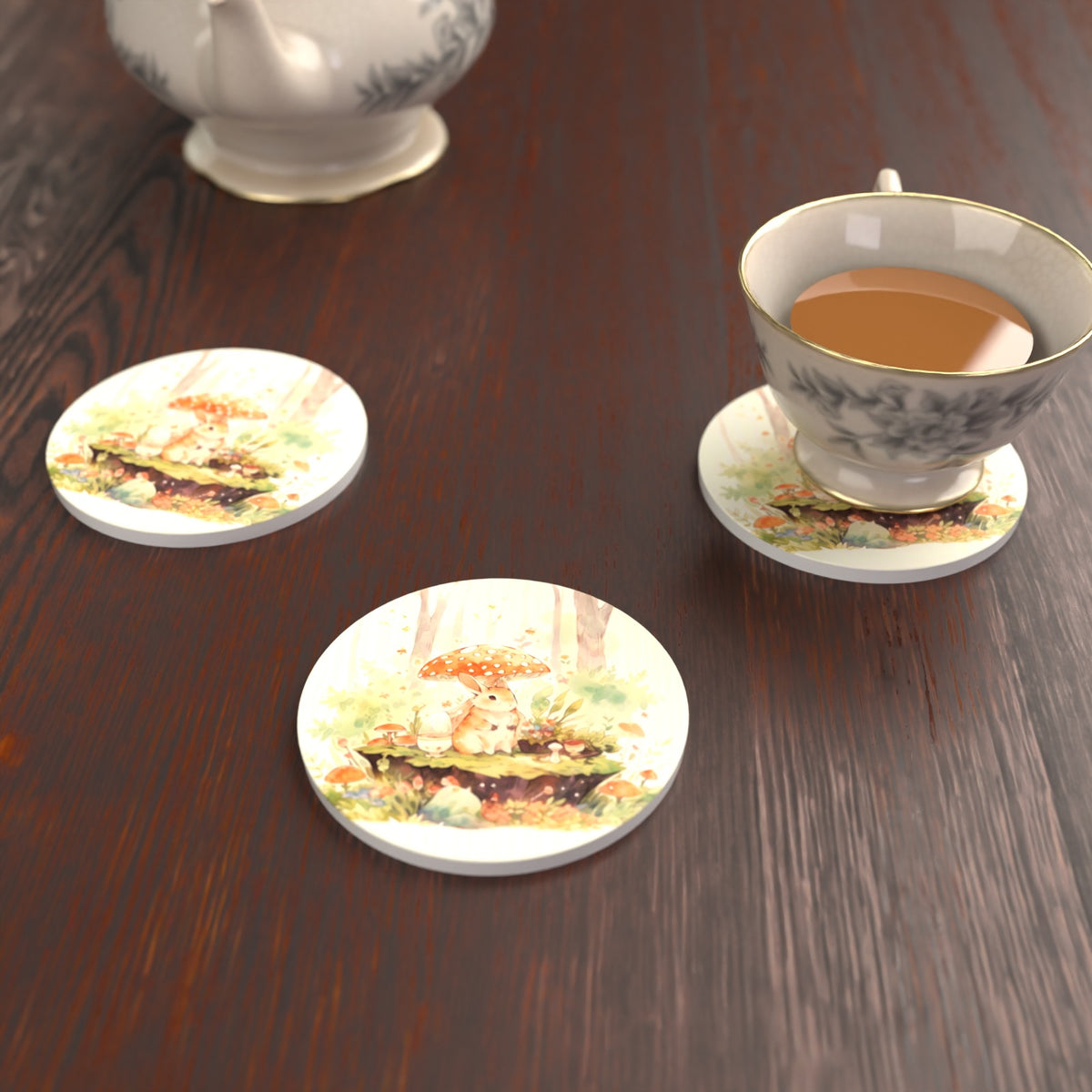 Rabbit under a Toadstool Round Ceramic Coasters – Set of 6 – lifestyle mockup with a teacup