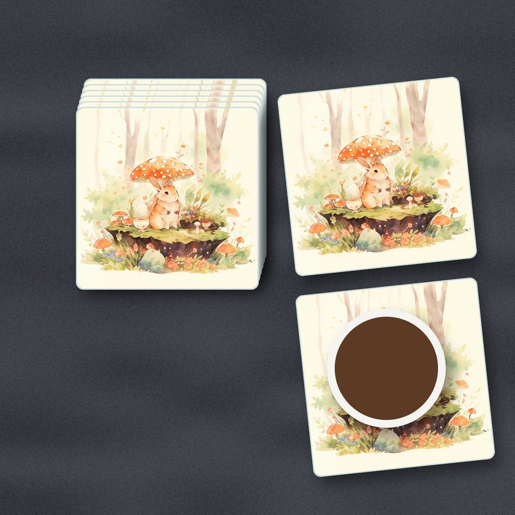 Rabbit under a Toadstool square glass coasters stacked on a slate kitchen worktop