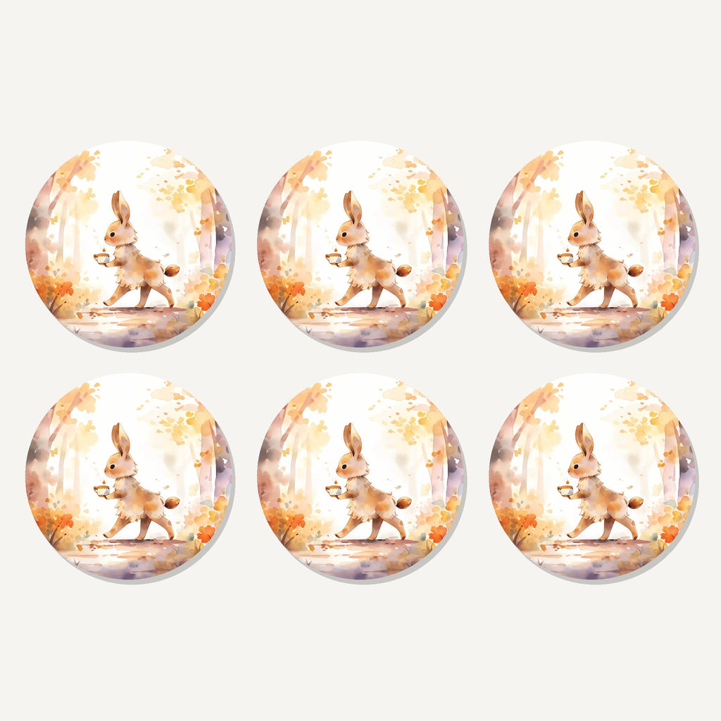 Flat lay of the rabbit on an autumn woodland path artwork on six round coasters