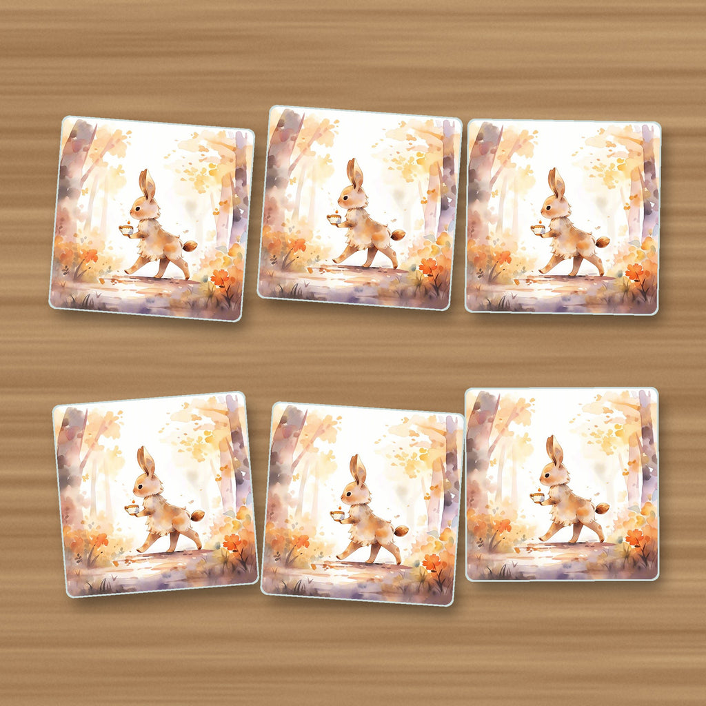 Rabbit on an Autumn Woodland Path square glass coasters, set of 6, on an oak coffee table