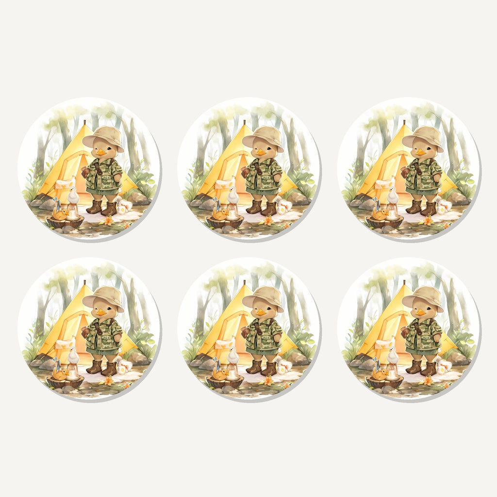 Flat lay of the duckling camper artwork on six round coasters