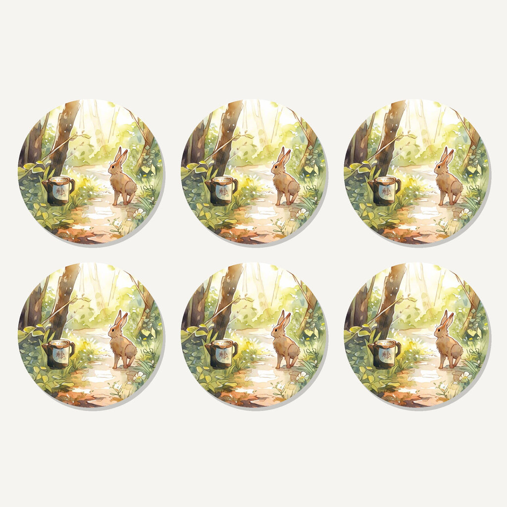 Flat lay of the hare on a sunny woodland path artwork on six round coasters