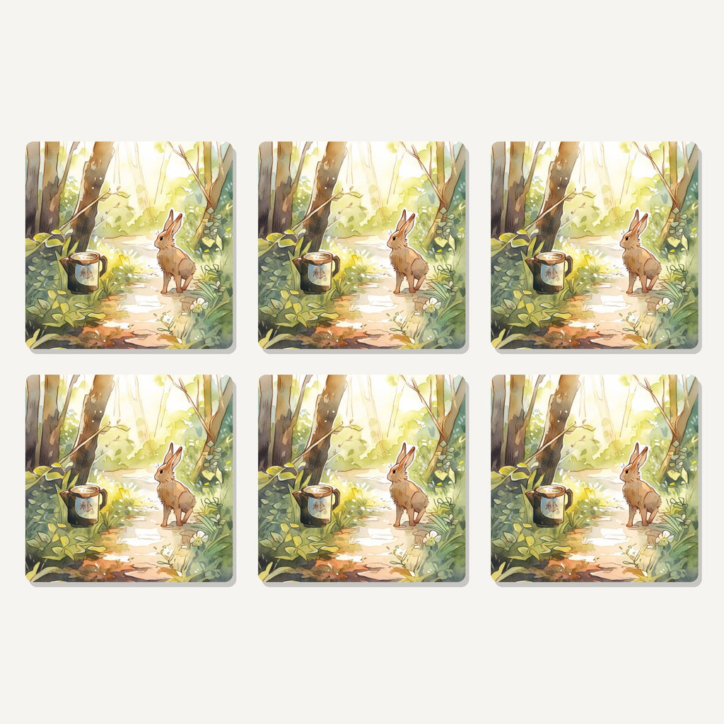 Flat lay of the hare on a sunny woodland path artwork on six square coasters