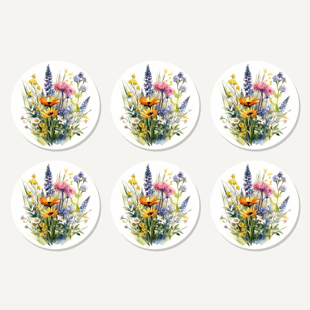 Flat lay of the watercolour wildflower posy artwork on six round coasters