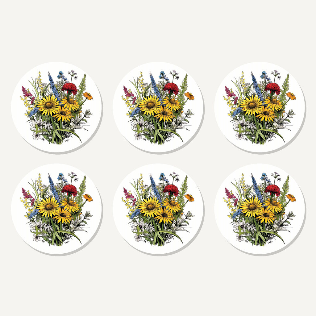 Flat lay of the sunflower bouquet with blue spires artwork on six round coasters