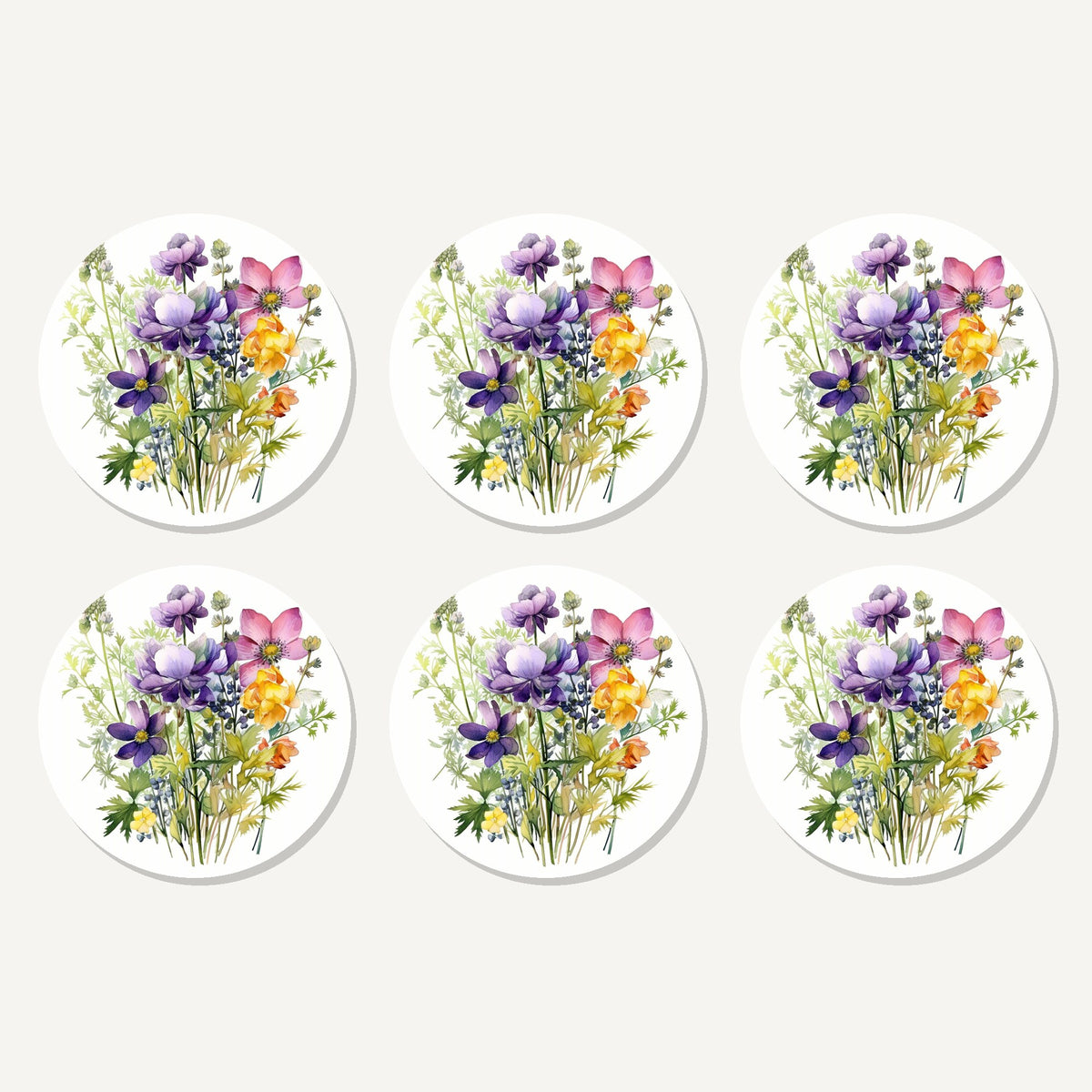 Flat lay of the purple & pink wildflower bouquet artwork on six round coasters
