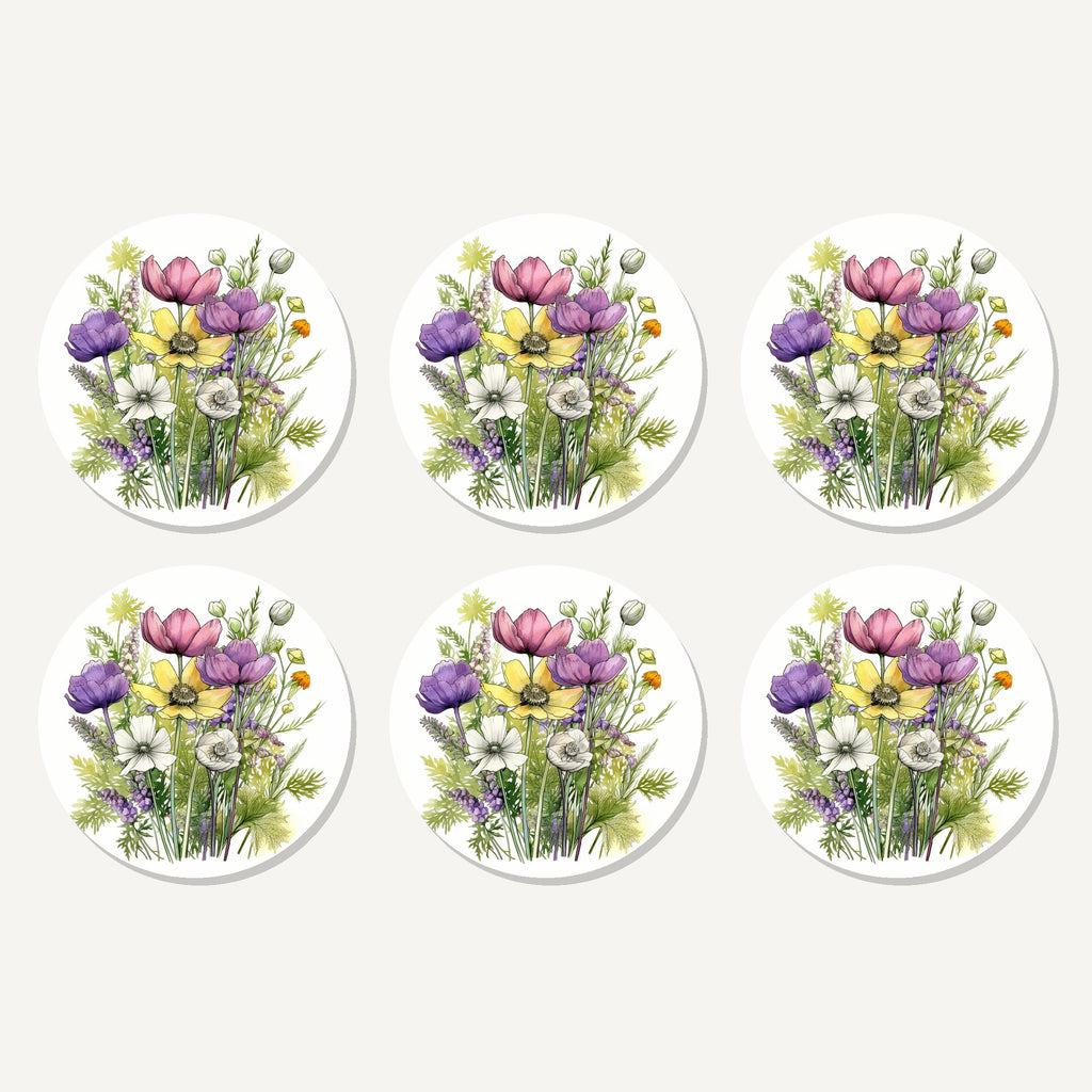 Flat lay of the pink, purple & white wild bouquet artwork on six round coasters