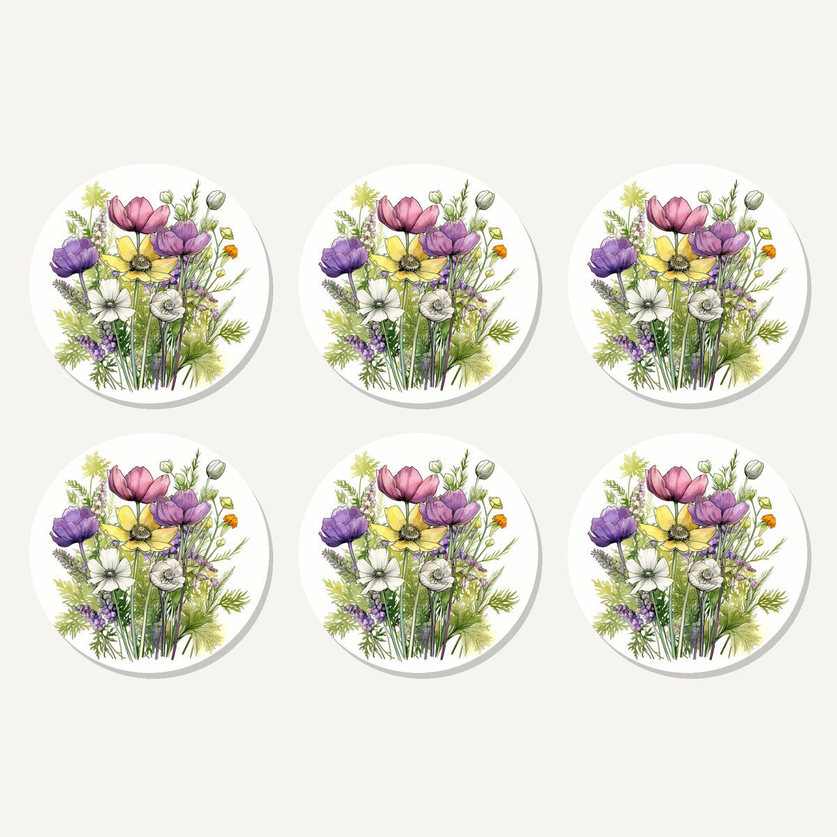 Flat lay of the pink, purple & white wild bouquet artwork on six round coasters