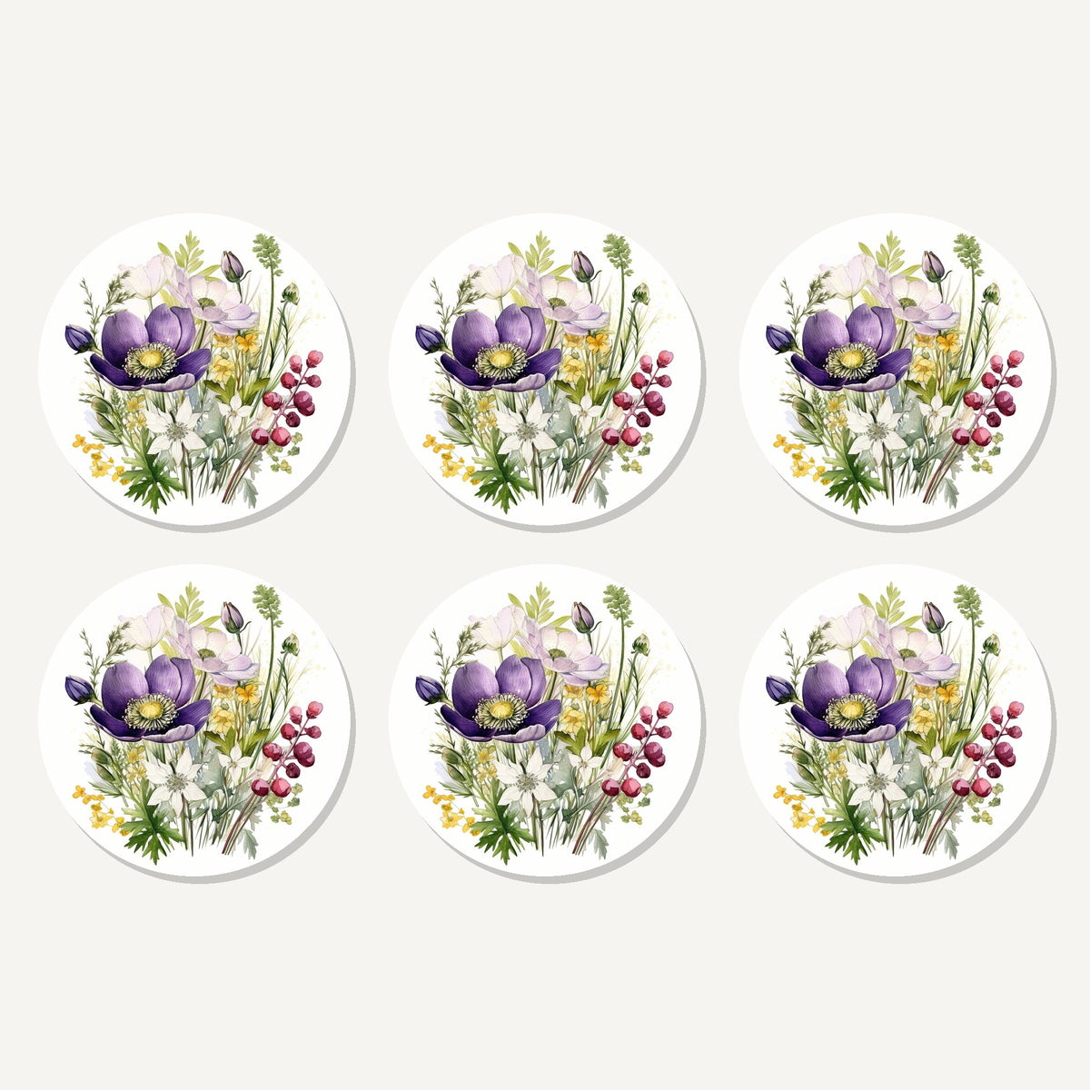 Flat lay of the purple anemone & berry bouquet artwork on six round coasters