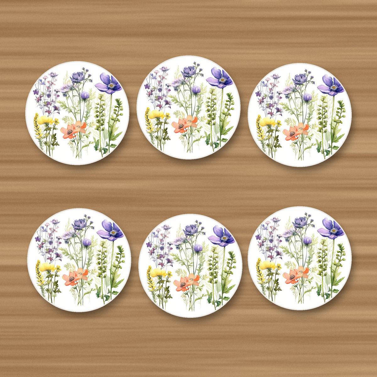 Delicate Purple & Peach Wildflowers round ceramic coasters, set of 6, on an oak coffee table