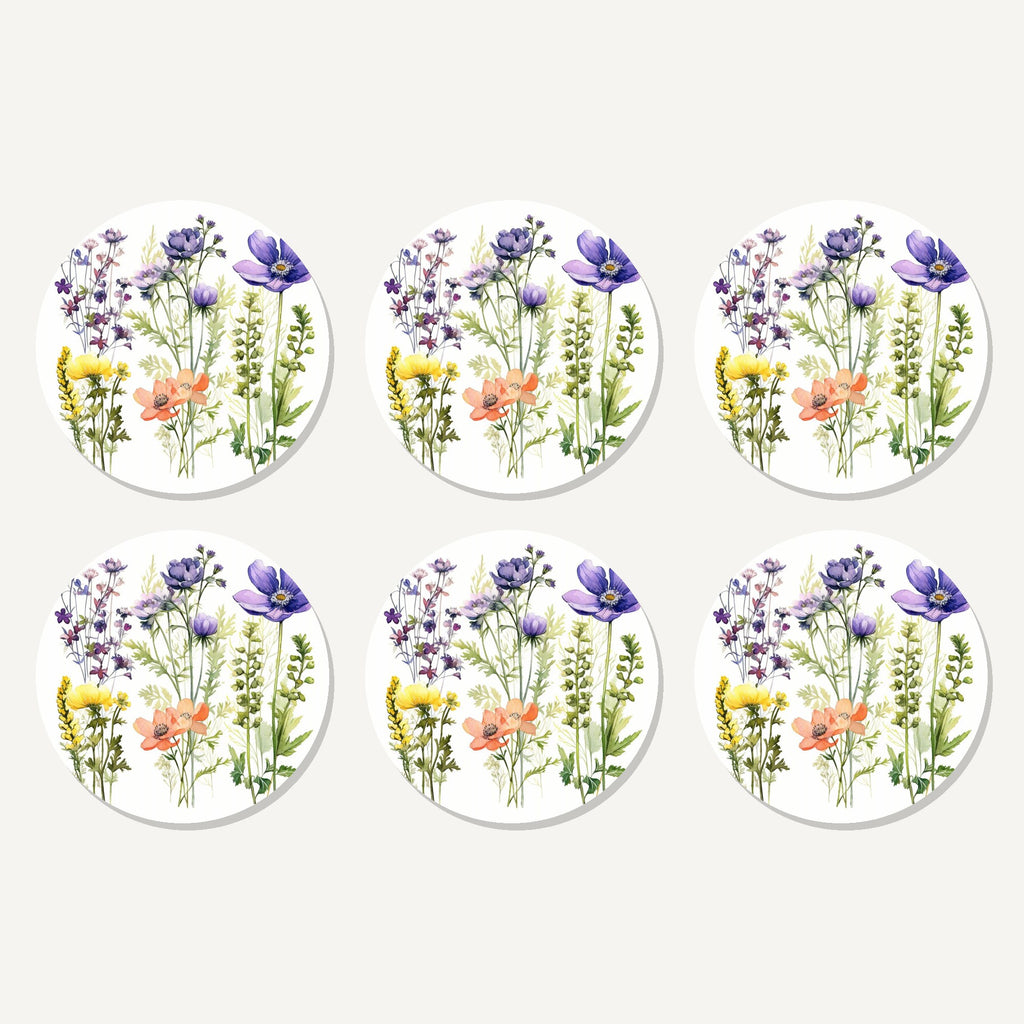 Flat lay of the delicate purple & peach wildflowers artwork on six round coasters