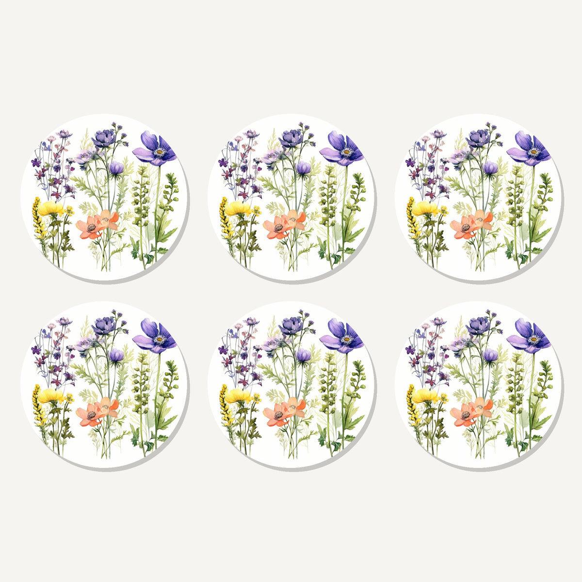 Flat lay of the delicate purple & peach wildflowers artwork on six round coasters