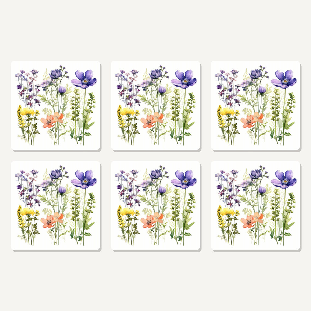 Flat lay of the delicate purple & peach wildflowers artwork on six square coasters