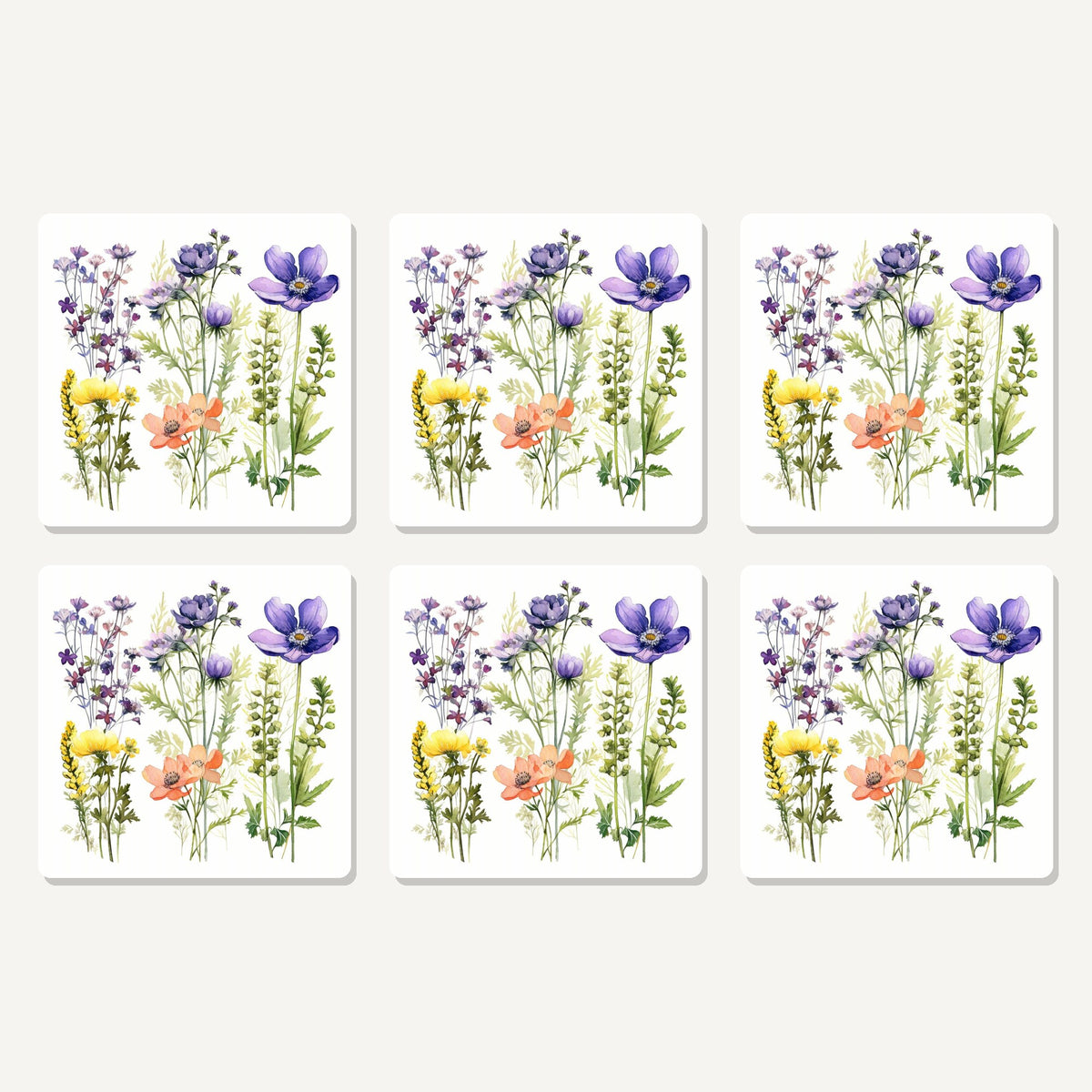 Flat lay of the delicate purple & peach wildflowers artwork on six square coasters