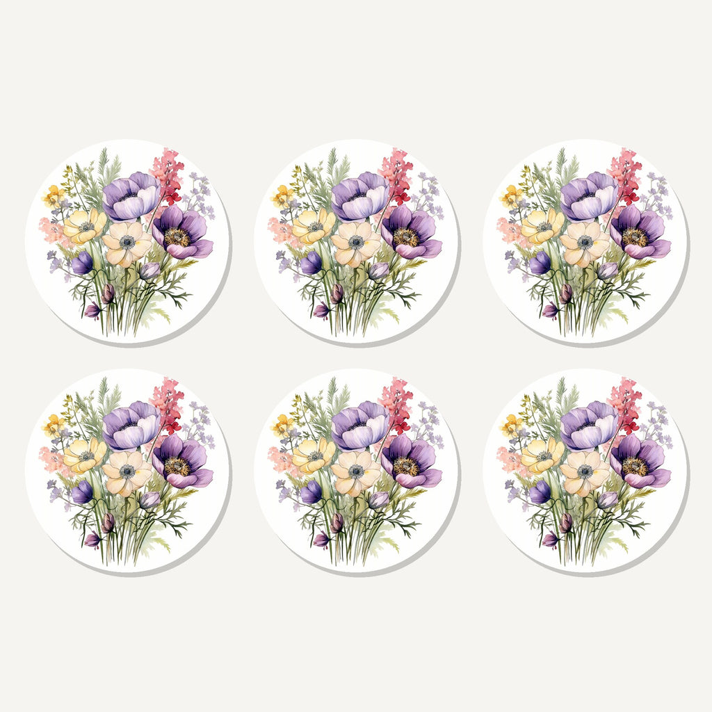 Flat lay of the lilac & cream anemone bouquet artwork on six round coasters